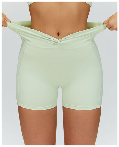 SPARK Twisted High Waist Yoga Shorts in green waist