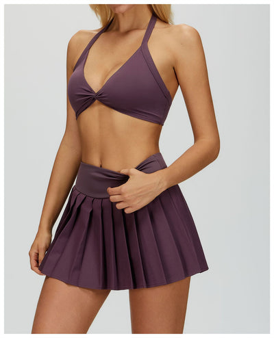 SPARK Women's Twist Halter Neck Yoga Bra in purple skirt